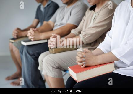 Religious christian team pray together for recovery give psychological support, counseling training trust concept, close up Stock Photo