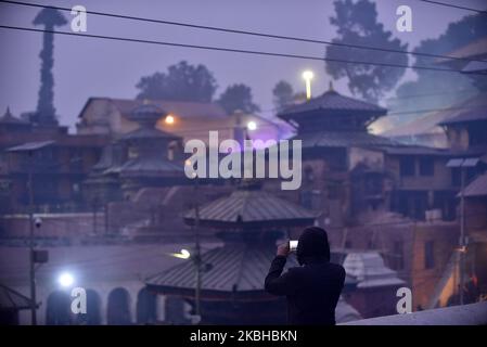 A devotee takes pictures of Pashupatinath Temple at the premises of Pashupatinath Temple, Kathmandu, Nepal on Thursday, February 20, 2020. Thousands of Hindu Sadhu or Holy man from India and Nepal come to celebrate Festival. (Photo by Narayan Maharjan/NurPhoto) Stock Photo