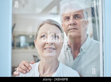 Family, couple and senior people at a window for looking, talking and embrace, happy and smile in their home. Glass, happy family and proud seniors Stock Photo