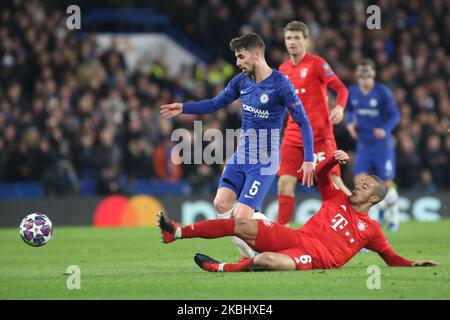 Jorginho (Chelsea) and Thiago (Bayern Munich) battle for the ball during the 2019/20 UEFA Champions League 1/8 playoff finale game between Chelsea FC (England) and Bayern Munich (Germany) at Stamford Bridge. (Photo by Federico Guerra Moran/NurPhoto) Stock Photo