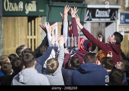 Boys chase after the leather ball during the annual game of hand ba’ that takes place in the Scottish town of Jedburgh in the Scottish Borders on February 27, 2020 in Jedburgh, United Kingdom. The game originating from the 1700’s consists of two teams, the ‘Uppies’ (born in the South of Jedburgh) and the ‘Doonies’ (born in the north of Jedburgh). The aim is to score goals at either end of the town by carrying a leather ball with ribbons past certain landmarks. The leather ball is used to represent an Englishman’s head with was originally used. (Photo by Ewan Bootman/NurPhoto) Stock Photo