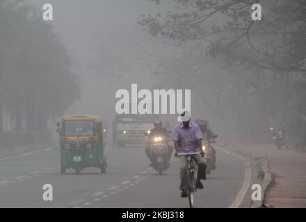 Commuters are seen on the road in today's foggy morning in the eastern Indian state Odisha's capital city Bhubaneswar, India, on February 28, 2020. Fog continues couple of days after the nonseasonal rain fall in the eastern parts of the country. (Photo by STR/NurPhoto) Stock Photo