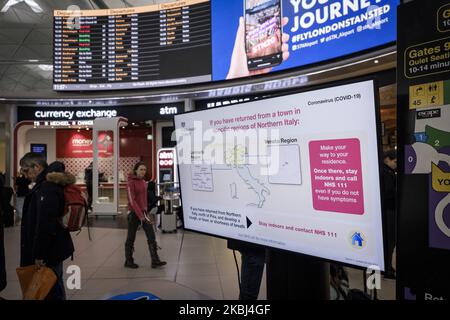 A screen in London Stansted airport warns passengers arriving from Northern Italy to contact health officials upon their arrival in the UK. London, 28th of February 2020. (Photo by Jacopo Landi/NurPhoto) Stock Photo