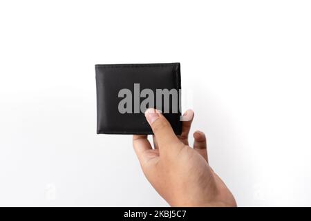 Hands hold a black empty wallet with no money inside. Stock Photo
