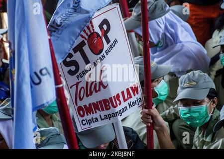 A number of workers who are members of the Trade Union rallied in the Batam city government area, Monday March 2, 2020. They reject the ratification of the Employment Copyright Omnibus Bill because workers claim not to be involved in the deliberation of the bill and its contents are considered to further reduce workers' welfare by eliminating the obligation to pay severance, abolishing the role of trade unions, the easy lay-off of workers and the imposition of wages based only on working hours (Photo by Teguh Prihatna/NurPhoto) Stock Photo