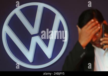 A man walks past the logo of Volkswagen during a car launch event on March 06, 2020 in Mumbai, India. (Photo by Himanshu Bhatt/NurPhoto) Stock Photo