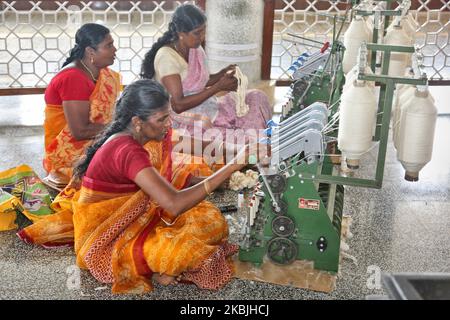 Women using modern machines to spin wool into yarn at the Gandhi Mandapam located in Kanyakumari, Tamil Nadu, India, on February 12, 2020. Built in 1956, the Gandhi Mandapam (Gandhi memorial) in Kanyakumari sits on the site where Gandhi's ashes were kept before they were scattered to the sea and features unique architectural details to honor the beloved leader's life. (Photo by Creative Touch Imaging Ltd./NurPhoto) Stock Photo