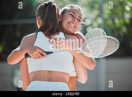 Badminton, happy and sports friends hug together for bond, love and care with smile on game break. Exercise, workout and happiness in women friendship Stock Photo