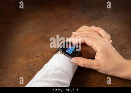 Woman hands checking unread emails from smartwatch. Over shoulder close up view. Female touching modern wearable technology concept idea. Stock Photo