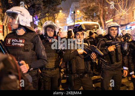 Protesters gathering for the International Women's Day march in Istanbul, Turkey, on March 8, 2020 were confronted by riot police on Siraselviler Street near Taksim Square, where dozens of women were tear gassed, pushed and tear gassed by security forces. Above, Turkish police officers stand together, holding rubber bullet and pellet guns, as they wait for orders regarding the protest. (Photo by Diego Cupolo/NurPhoto) Stock Photo