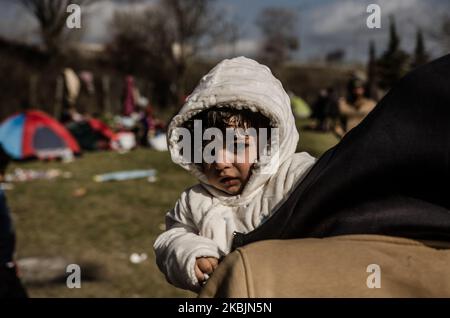 Child is seen holding on hands by his sister. Many children suffer because of the migrants crisis along Turkey-Greece border. There are many families with kids trying to start a new life somewhere in the EU. For now, they are stranded in parking lots, on bus stations in Edirne, or even in the no man's land between Pazarkule and Kastanies, Edirne, Turkey on March 9, 2020 (Photo by Hristo Rusev/NurPhoto) Stock Photo