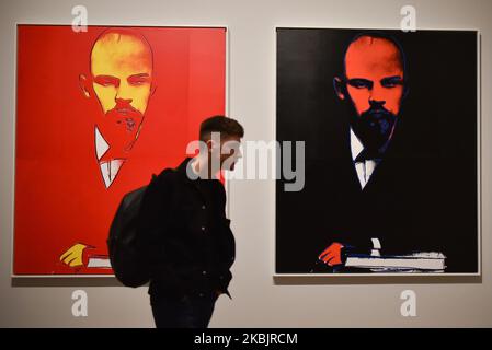 A gallery assistant poses with an arwork entitled 'Lenin, 1986' by US artist Andy Warhol during a press preview for the forthcoming Andy Warhol exhibition at the Tate Modern in London on March 10, 2020. - The exhibition is set to run from March 12 to September 6. RESTRICTED TO EDITORIAL USE - MANDATORY MENTION OF THE ARTIST UPON PUBLICATION - TO ILLUSTRATE THE EVENT AS SPECIFIED IN THE CAPTION (Photo by Alberto Pezzali/NurPhoto) Stock Photo