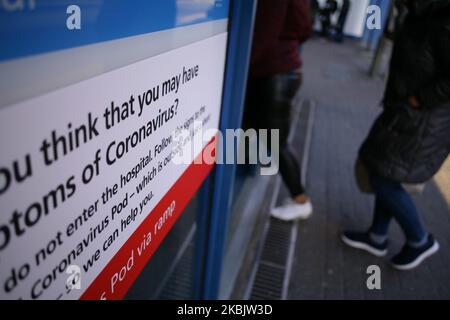 A sign directing people with symptoms of the covid-19 coronavirus to a 'coronavirus pod' isolation unit covers a window of an entrance to St Mary's Hospital in London, England, on March 11, 2020. In the UK, 460 people have now been confirmed to have the virus. Six patients with coronavirus have so far died in hospitals around the country. The World Health Organisation (WHO) meanwhile today officially designated the global spread of the illness as a pandemic. (Photo by David Cliff/NurPhoto) Stock Photo