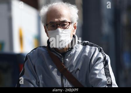 A man, wearing protective mask following an outbreak of the coronavirus disease (COVID-19), walks in Tokyo, Japan, March 13, 2020. (Photo by Hitoshi Yamada/NurPhoto) Stock Photo