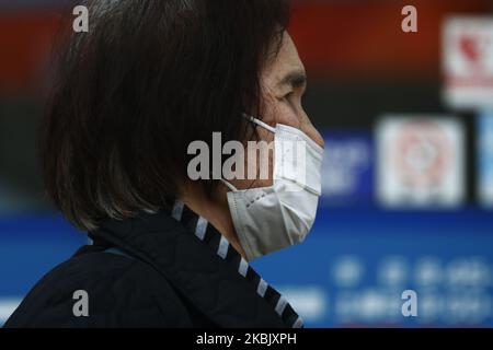 A woman, wearing protective mask following an outbreak of the coronavirus disease (COVID-19), walks in Tokyo, Japan, March 13, 2020. (Photo by Hitoshi Yamada/NurPhoto) Stock Photo