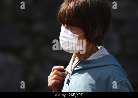 A woman, wearing protective mask following an outbreak of the coronavirus disease (COVID-19), walks in Tokyo, Japan, March 13, 2020. (Photo by Hitoshi Yamada/NurPhoto) Stock Photo