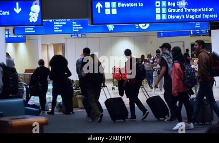 Travelers arrive at Orlando International Airport in Orlando, Florida several hours before the temporary ban on air passengers from Europe ordered by President Trump was set to go into effect at midnight on March 13, 2020, in an effort to curb the spread of the coronavirus (COVID-19) outbreak in the United States. (Photo by Paul Hennessy/NurPhoto) Stock Photo