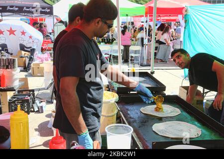 Man prepares Masala dosas as food vendors showcase tasty and exotic delicacies and a variety of street food from across India during the Taste of India food festival at Nathan Philips Square in Toronto, Ontario, Canada, on August 04, 2019. (Photo by Creative Touch Imaging Ltd./NurPhoto) Stock Photo