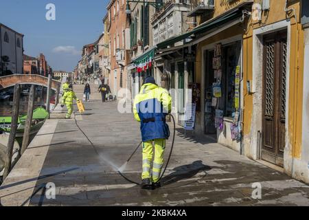 Workers wash and disinfect as special street cleaning made by the Municipality Company Veritas in the area of Cannaregio, Venice, Italy, on March 17, 2020 using a pressure washer installed on a boat during Covid-19 Emergency. (Photo by Giacomo Cosua/NurPhoto) Stock Photo