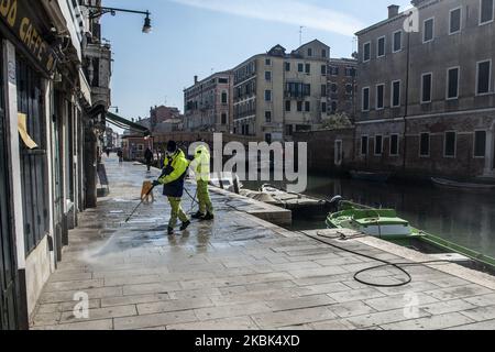 Workers wash and disinfect as special street cleaning made by the Municipality Company Veritas in the area of Cannaregio, Venice, Italy, on March 17, 2020 using a pressure washer installed on a boat during Covid-19 Emergency. (Photo by Giacomo Cosua/NurPhoto) Stock Photo