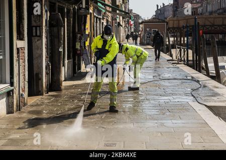 Workers wash and disinfect as special street cleaning made by the Municipality Company Veritas in the area of Cannaregio, Venice, Italy, on March 17, 2020 using a pressure washer installed on a boat during Covid-19 Emergency. (Photo by Giacomo Cosua/NurPhoto) Stock Photo