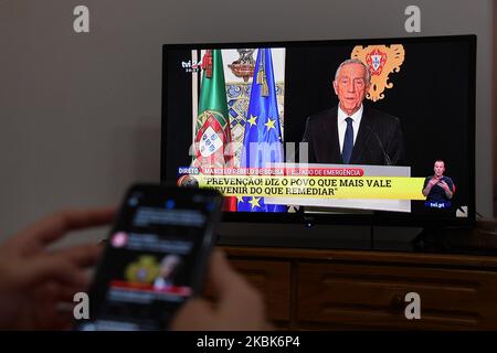 A woman observes the televised statement by Portugal's President Marcelo de Sousa in which he plunges Portugal into a state of emergency, in Lisbon, on March 18, 2020. Portugal's President Marcelo Rebelo de Sousa has declared a state of emergency due to the coronavirus epidemic that has so far infected 642 people, two of them deadly (Photo by Jorge Mantilla/NurPhoto) Stock Photo