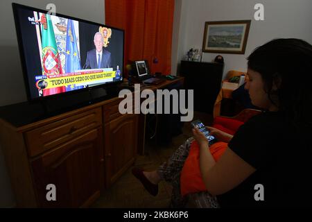 A woman observes the televised statement by Portugal's President Marcelo de Sousa in which he plunges Portugal into a state of emergency, in Lisbon, on March 18, 2020. Portugal's President Marcelo Rebelo de Sousa has declared a state of emergency due to the coronavirus epidemic that has so far infected 642 people, two of them deadly (Photo by Jorge Mantilla/NurPhoto) Stock Photo