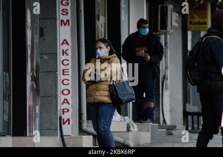 People with protective mask are seen waiting to come inside a shop in one of the biggest green market in Varna, Bulgaria, on March 18, 2020. The Bulgarian government banned people from gathering in groups. Restaurants and bakeries can only sell food for home. Coffee shops, night clubs theaters and cinemas are closed. Employees are encouraged to work from. This is done to prevent the spread of COVID-19. In the following month only governmental institutions, pharmacies and food shops will be open. Department of Health has confirmed 92 cases of coronavirus in Bulgaria, with at least two recorded  Stock Photo