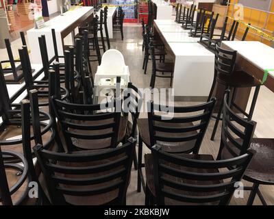 Chairs seen in an empty food court in a shopping mall in Toronto, Ontario, Canada on March 21, 2020. Restaurants have been prohibited from allowing dine-in service and food courts and cafeterias have been ordered to be closed by the Province of Ontario, with any deciding to remain open facing steep fines and penalties. Retailers in malls across Canada have shuttered their stores due to the novel coronavirus (COVID-19) outbreak. Many malls are limiting entry to only 50 visitors at a time. (Photo by Creative Touch Imaging Ltd./NurPhoto) Stock Photo