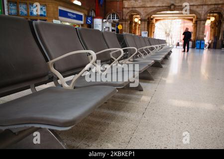 Empty chairs sit in the concourse of a near-deserted Marylebone Station in London, England, on March 23, 2020. Train services across the country began to be scaled back from today amid huge falls in passenger demand. Core services are continuing, however, primarily to allow healthcare workers, emergency services personnel and other so-called key workers to reach their workplaces. Rail franchise agreements are also to be temporarily suspended, the Department for Transport (DfT) announced today, with the government effectively nationalising the railways to protect train companies from collapsing Stock Photo