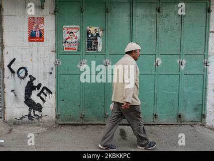 A man passes by political and social mural paintings and posters on the wall in Bethlehem. On Thursday, March 5, 2020, in Bethlehem, Palestine (Photo by Artur Widak/NurPhoto) Stock Photo