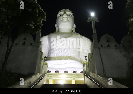 The giant Bahiravokanda Vihara Buddha Statue illuminated at night at the Sri Maha Bodhi Viharaya Buddhist temple in Kandy, Sri Lanka. The temple located in Bahirawakanda and is known for its giant Buddha statue. The statue of Buddha is depicted in the position of the Dhyana Mudra, the posture of meditation associated with his first Enlightenment, and can be seen from almost everywhere in Kandy. The statue is 26.83 m (88.0 ft) high and is one of the tallest Buddha statues in Sri Lanka. (Photo by Creative Touch Imaging Ltd./NurPhoto) Stock Photo