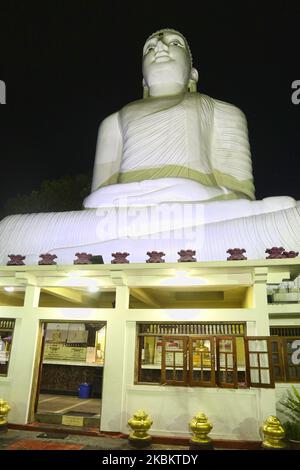 The giant Bahiravokanda Vihara Buddha Statue illuminated at night at the Sri Maha Bodhi Viharaya Buddhist temple in Kandy, Sri Lanka. The temple located in Bahirawakanda and is known for its giant Buddha statue. The statue of Buddha is depicted in the position of the Dhyana Mudra, the posture of meditation associated with his first Enlightenment, and can be seen from almost everywhere in Kandy. The statue is 26.83 m (88.0 ft) high and is one of the tallest Buddha statues in Sri Lanka. (Photo by Creative Touch Imaging Ltd./NurPhoto) Stock Photo