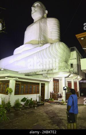 The giant Bahiravokanda Vihara Buddha Statue illuminated at night at the Sri Maha Bodhi Viharaya Buddhist temple in Kandy, Sri Lanka. The temple located in Bahirawakanda and is known for its giant Buddha statue. The statue of Buddha is depicted in the position of the Dhyana Mudra, the posture of meditation associated with his first Enlightenment, and can be seen from almost everywhere in Kandy. The statue is 26.83 m (88.0 ft) high and is one of the tallest Buddha statues in Sri Lanka. (Photo by Creative Touch Imaging Ltd./NurPhoto) Stock Photo