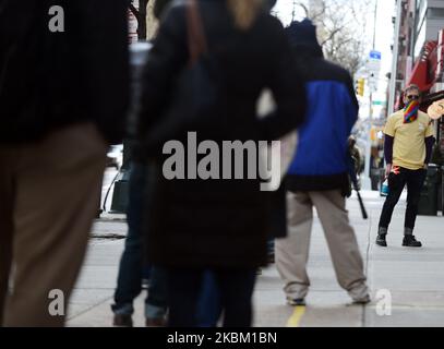 New Yorkers wait in line at a Trader Joe's grocery store, on April 4, 2020. (Photo by B.A. Van Sise/NurPhoto) Stock Photo