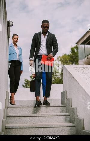 Business people walking down the stairs at the building Stock Photo