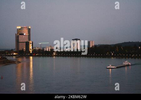 a cargo passes the rhine river while the Marriott Hotel Bonn with heart of lights is seen in Bonn, Germany, on April 8, 2020 during the Coronavirus emergency. (Photo by Ying Tang/NurPhoto) Stock Photo