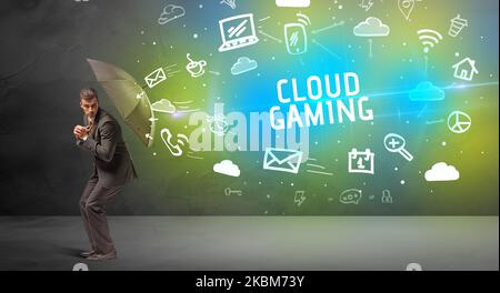 Businessman defending with umbrella, modern technology concept Stock Photo