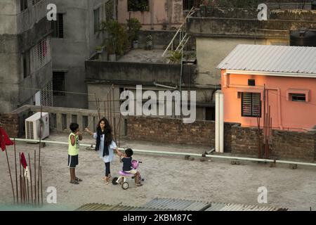 Children playing on the rooftop of a building during government-imposed lockdown as a preventive measure against the COVID-19 coronavirus in Dhaka, Bangladesh on April 10, 2020. (Photo by Zakir Hossain Chowdhury/NurPhoto) Stock Photo