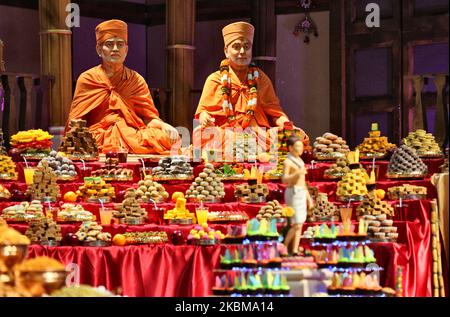 Mountains of sweets and vegetarian snacks are displayed in front of the deities at the BAPS Shri Swaminarayan Temple during the Annakut Darshan (also known as Annakut Utsav and Govardhan Puja) which takes place on fifth and final day of the festival of Diwali, which marks the start of the Hindu New Year, in Toronto, Ontario, Canada on October 28, 2019. Annakut which means a 'large mountain of food' which is offered to God as a sign of devotion. BAPS (Bochasanwasi Shri Akshar Purushottam Swaminarayan Sanstha) is a sect of Hinduism's Diksha Vidhi and their temples, though dedicated to many Hindu Stock Photo