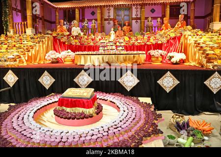 Mountains of sweets and vegetarian snacks are displayed in front of the deities at the BAPS Shri Swaminarayan Temple during the Annakut Darshan (also known as Annakut Utsav and Govardhan Puja) which takes place on fifth and final day of the festival of Diwali, which marks the start of the Hindu New Year, in Toronto, Ontario, Canada on October 28, 2019. Annakut which means a 'large mountain of food' which is offered to God as a sign of devotion. BAPS (Bochasanwasi Shri Akshar Purushottam Swaminarayan Sanstha) is a sect of Hinduism's Diksha Vidhi and their temples, though dedicated to many Hindu Stock Photo