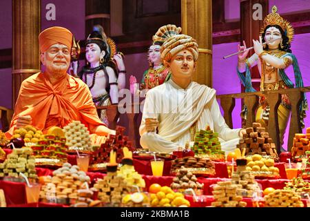 Mountains of sweets and vegetarian snacks are displayed in front of the deities at the BAPS Shri Swaminarayan Temple during the Annakut Darshan (also known as Annakut Utsav and Govardhan Puja) which takes place on fifth and final day of the festival of Diwali, which marks the start of the Hindu New Year, in Toronto, Ontario, Canada on October 28, 2019. Annakut which means a 'large mountain of food' which is offered to God as a sign of devotion. BAPS (Bochasanwasi Shri Akshar Purushottam Swaminarayan Sanstha) is a sect of Hinduism's Diksha Vidhi and their temples, though dedicated to many Hindu Stock Photo