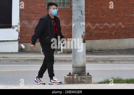 Man wearing a face mask to protect him from the novel coronavirus (COVID-19) in Toronto, Ontario, Canada on April 12, 2020. (Photo by Creative Touch Imaging Ltd./NurPhoto) Stock Photo