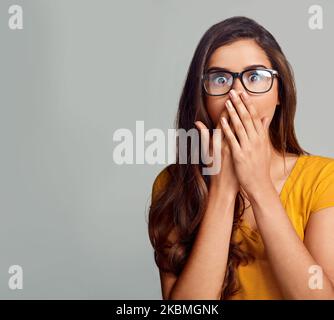You cant be serious, right. Studio portrait of an attractive young woman looking surprised against a grey background. Stock Photo