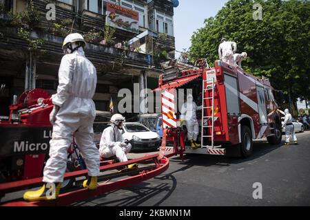 Firefighters prepare to spray disinfectant in the street as a preventive measure against the COVID-19 coronavirus in Yangon, Myanmar on April 21, 2020. Myanmar has reported a total of 119 confirmed cases with 5 deaths. (Photo by Shwe Paw Mya Tin/NurPhoto) Stock Photo