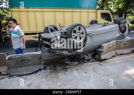 The badly damaged Mercedes in single accident is lying on the roof in Jakarta, Indonesia on April 22, 2020. The accident was caused by a car crashing into a roadblock at high speed during the Jakarta's Large-Scale Social Restrictions that extended 28 Days between until 22 May in an attempt to curb the widespread of the SARS-CoV-2 coronavirus. (Photo by Afriadi Hikmal/NurPhoto) Stock Photo