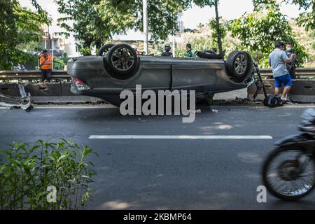 The badly damaged Mercedes in single accident is lying on the roof in Jakarta, Indonesia on April 22, 2020. The accident was caused by a car crashing into a roadblock at high speed during the Jakarta's Large-Scale Social Restrictions that extended 28 Days between until 22 May in an attempt to curb the widespread of the SARS-CoV-2 coronavirus. (Photo by Afriadi Hikmal/NurPhoto) Stock Photo