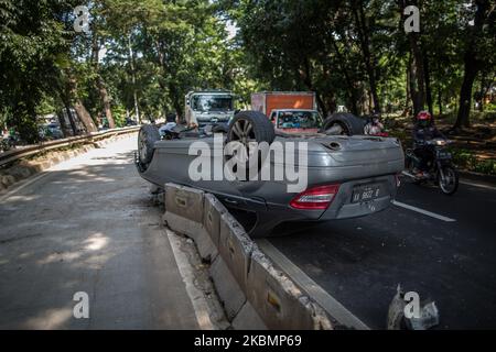 The badly damaged Mercedes in single accident is lying on the roof in Jakarta, Indonesia on April 22, 2020. The accident was caused by a car crashing into a roadblock at high speed during the Jakarta's Large-Scale Social Restrictions that extended 28 Days between until 22 May in an attempt to curb the widespread of the SARS-CoV-2 coronavirus. (Photo by Afriadi Hikmal/NurPhoto) Stock Photo