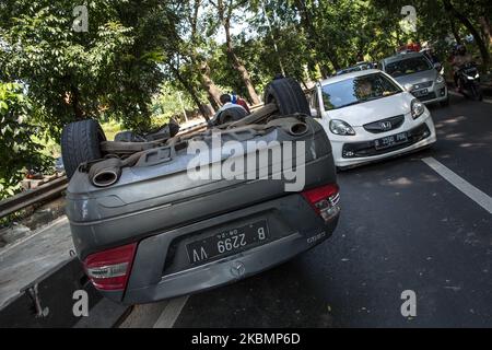 The badly damaged Mercedes in single accident is lying on the roof in Jakarta, Indonesia on April 22, 2020. The accident was caused by a car crashing into a roadblock at high speed during the Jakarta's Large-Scale Social Restrictions that extended 28 Days between until 22 May in an attempt to curb the widespread of the SARS-CoV-2 coronavirus. (Photo by Afriadi Hikmal/NurPhoto) Stock Photo