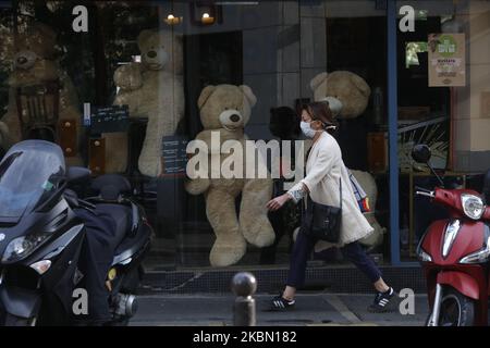 A woman walks a front a teddy bears inside a closed cafe in the 'Les Gobelins' area in Paris, as a lockdown is imposed to slow the rate of the coronavirus disease (COVID-19) in France, April 27, 2020. (Photo by Mehdi Taamallah/NurPhoto) Stock Photo